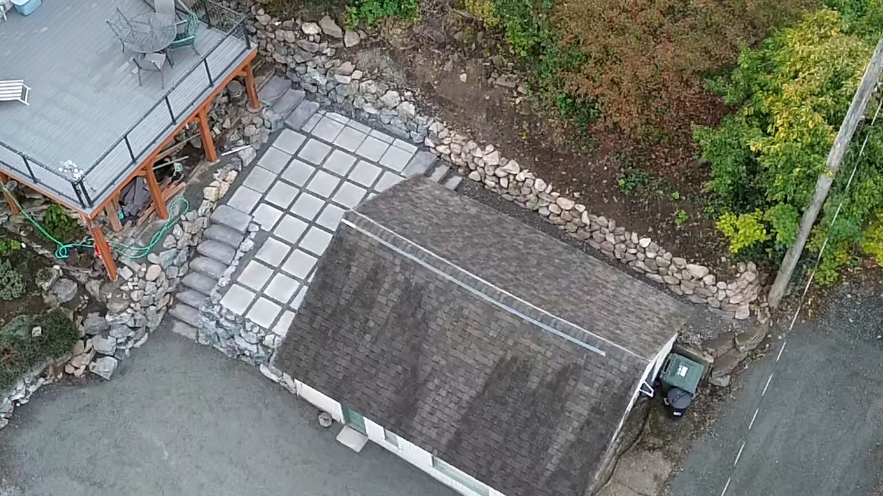 Backyard after — paver patio and retaining wall, aerial view