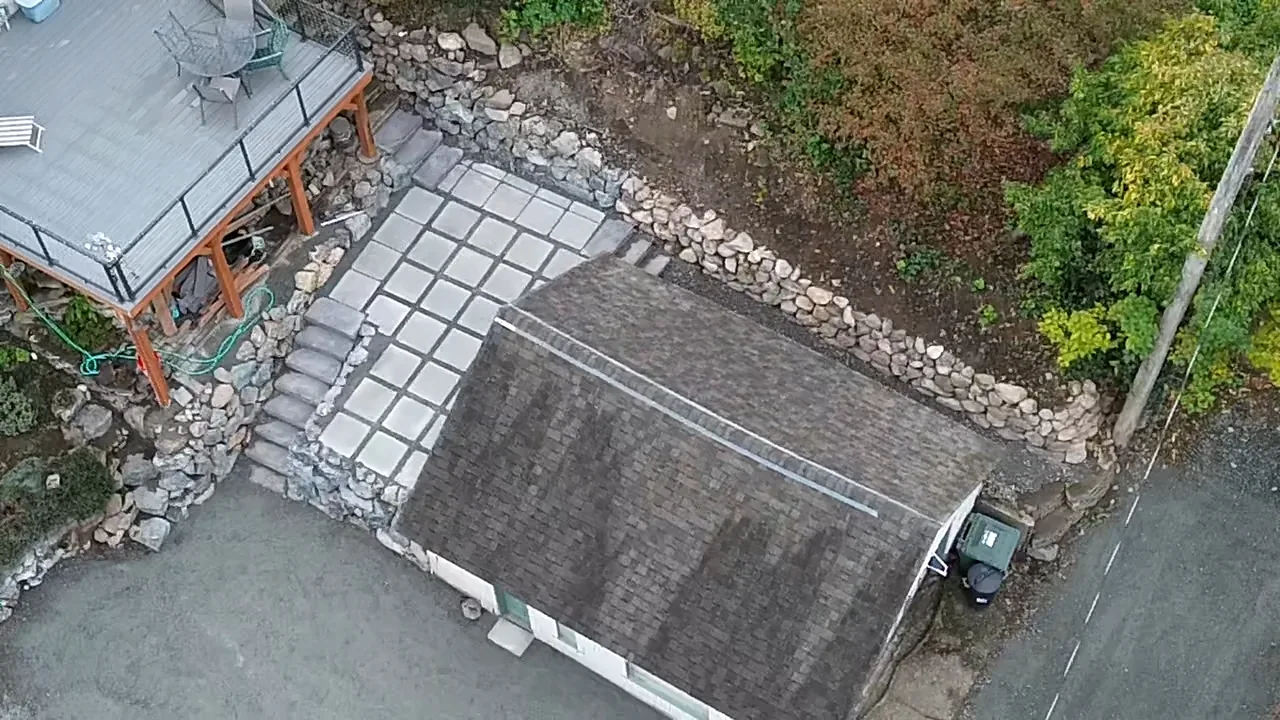 Backyard after — paver patio and retaining wall, aerial view