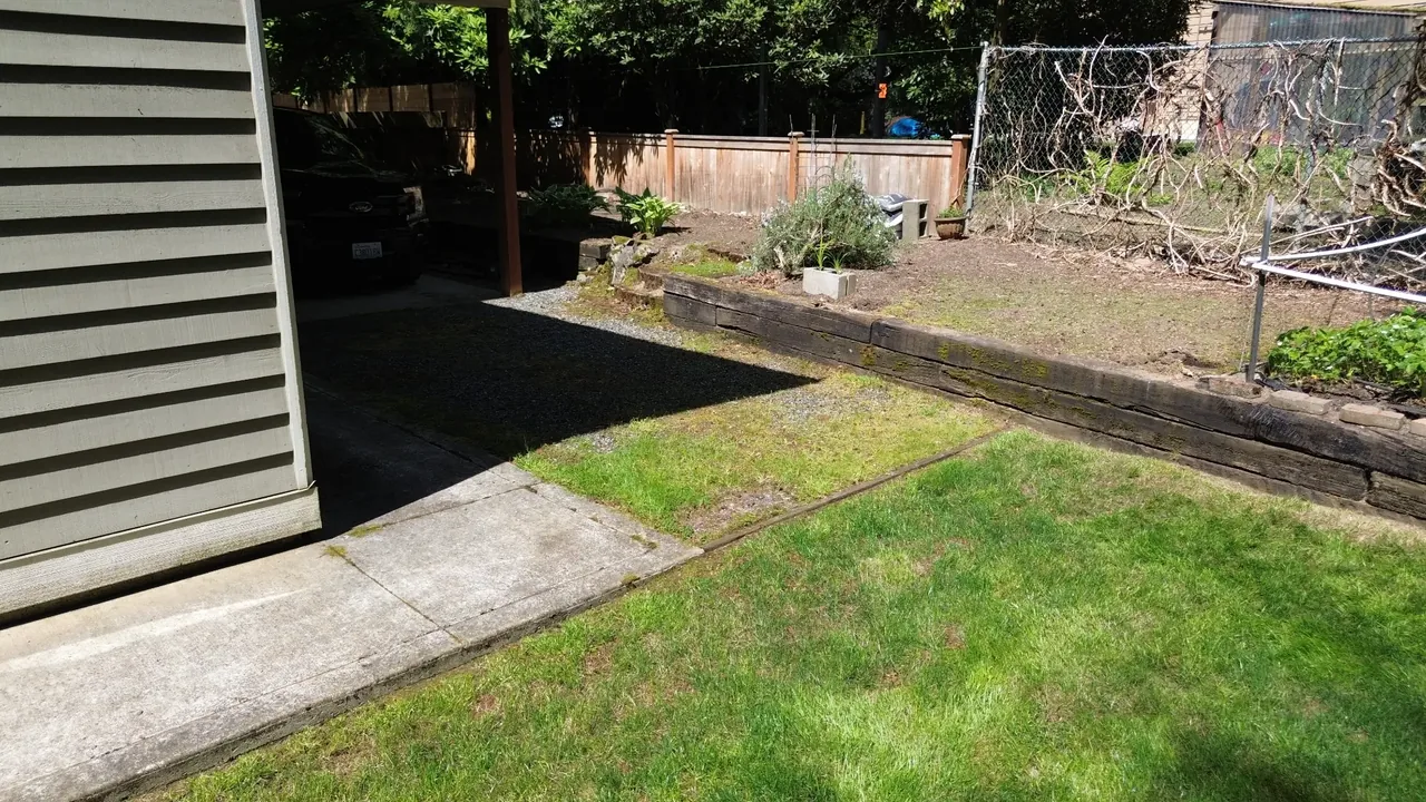 Before — old timber retaining wall along backyard edge