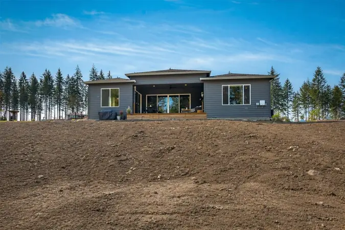 Bare slope before — new construction with no landscaping