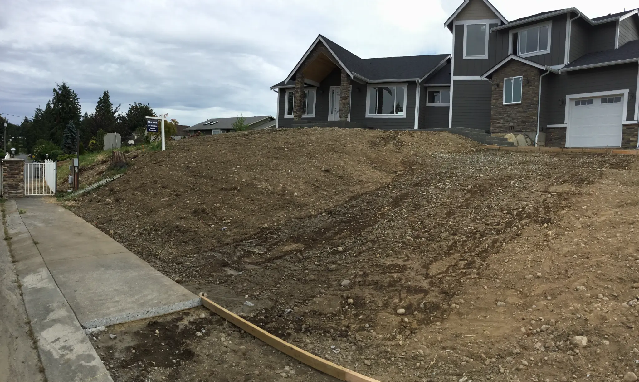 New construction front yard before — bare dirt, no landscaping