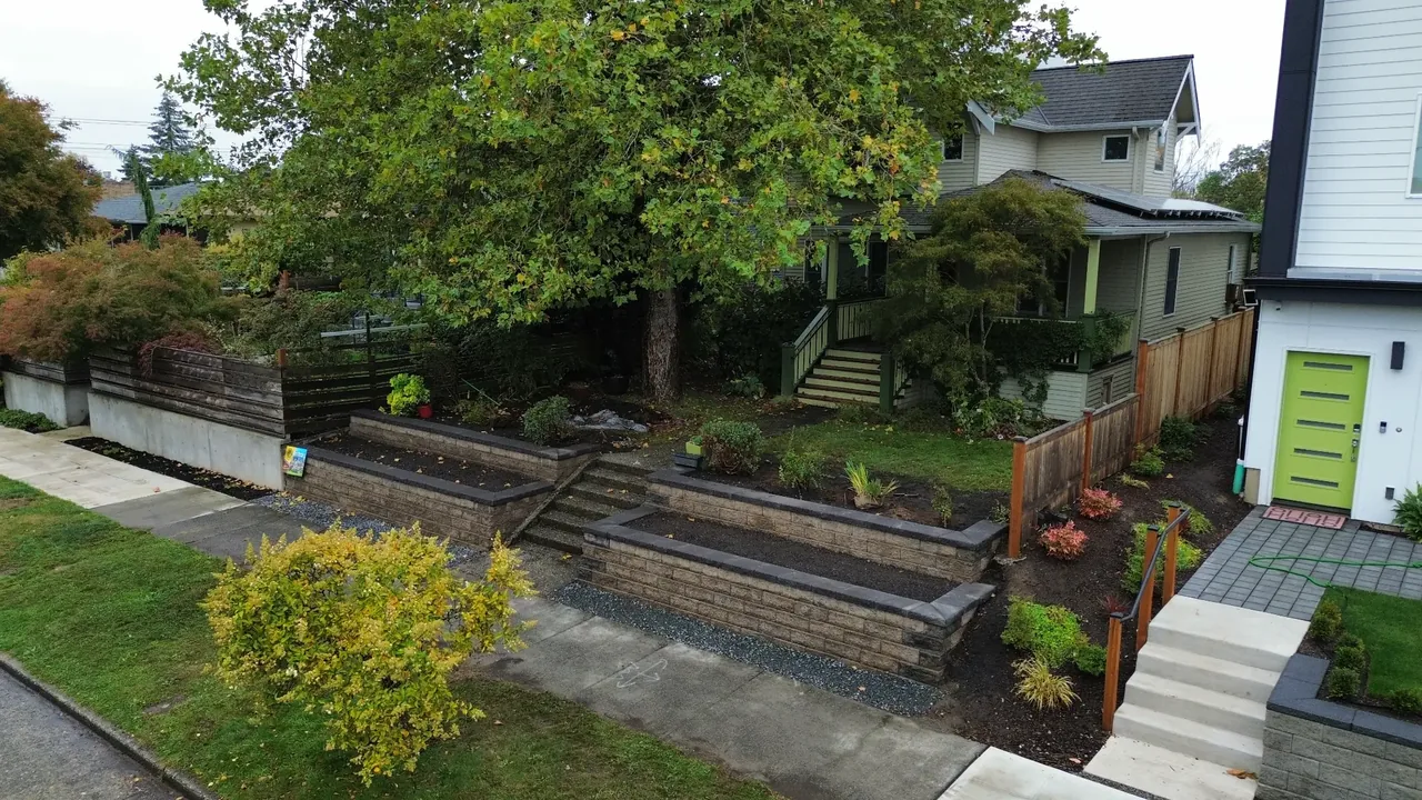 After — new concrete block terraced retaining wall with landscaping