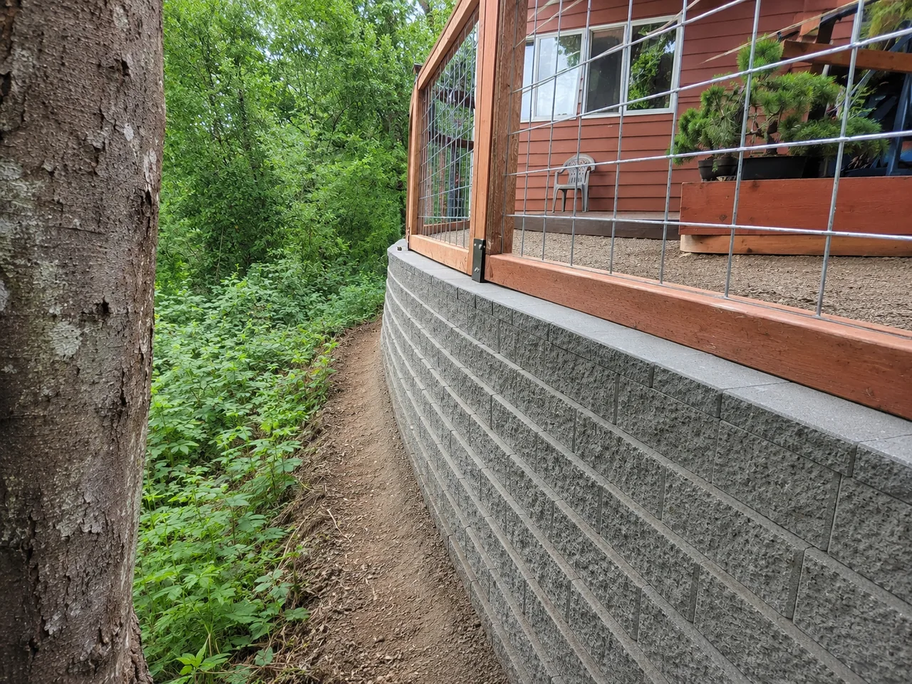 After — clean curved concrete block retaining wall