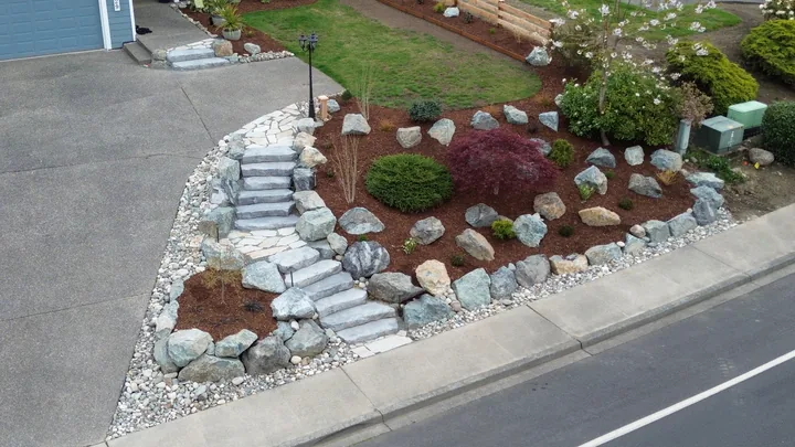 Corner lot after — terraced rockery walls and stone steps