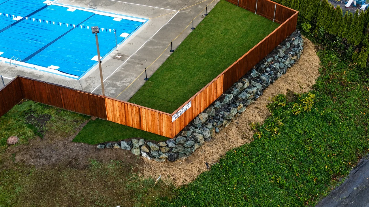 Madison Park swim club after — natural stone rockery wall with cedar fence