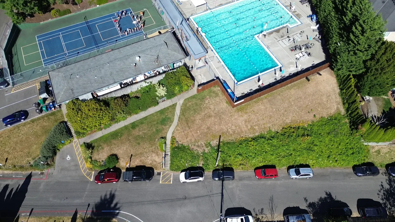 Madison Park swim club before — dry grass slope, no wall